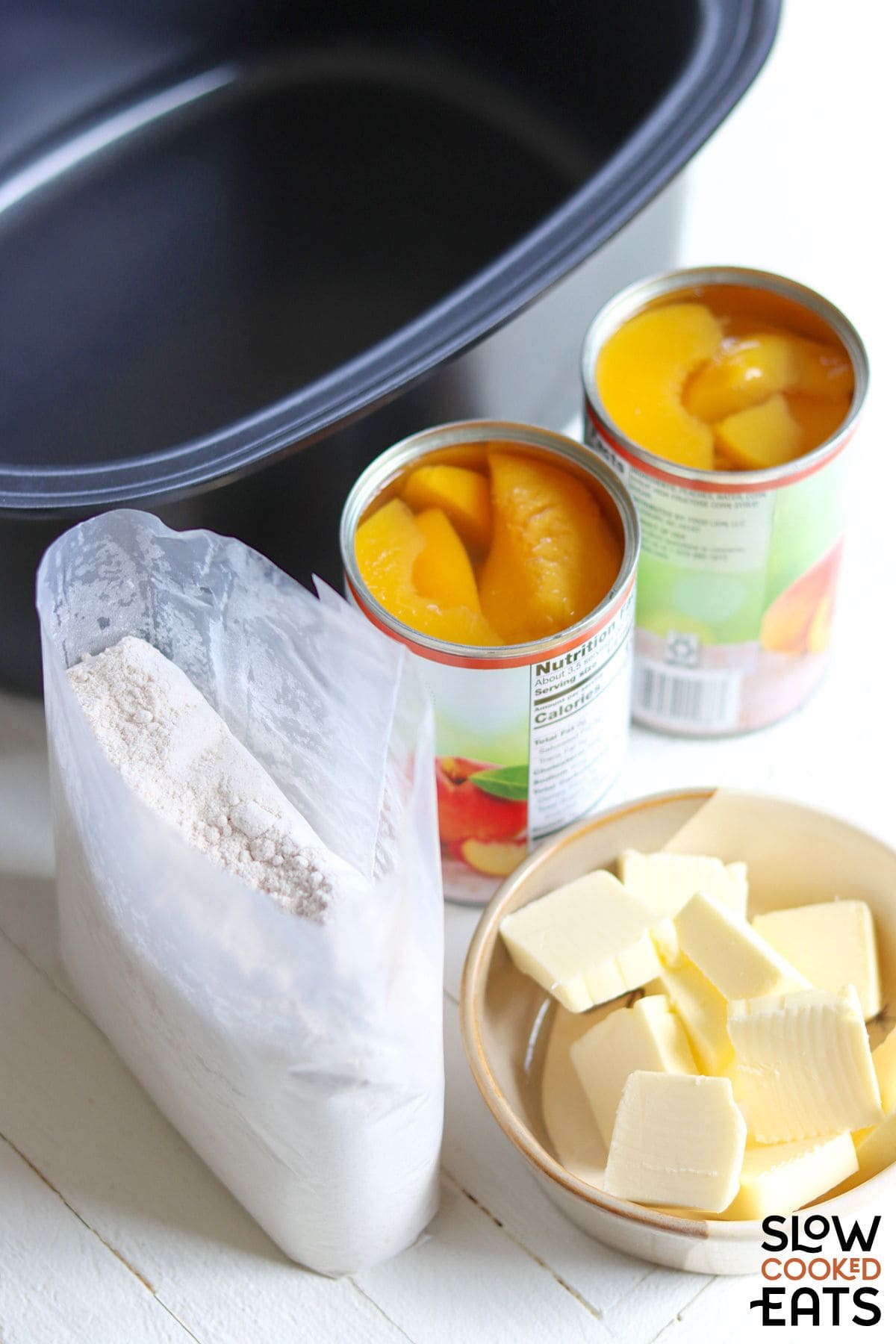 Ingredients needed to make easy crock pot peach cobbler with cake mix.