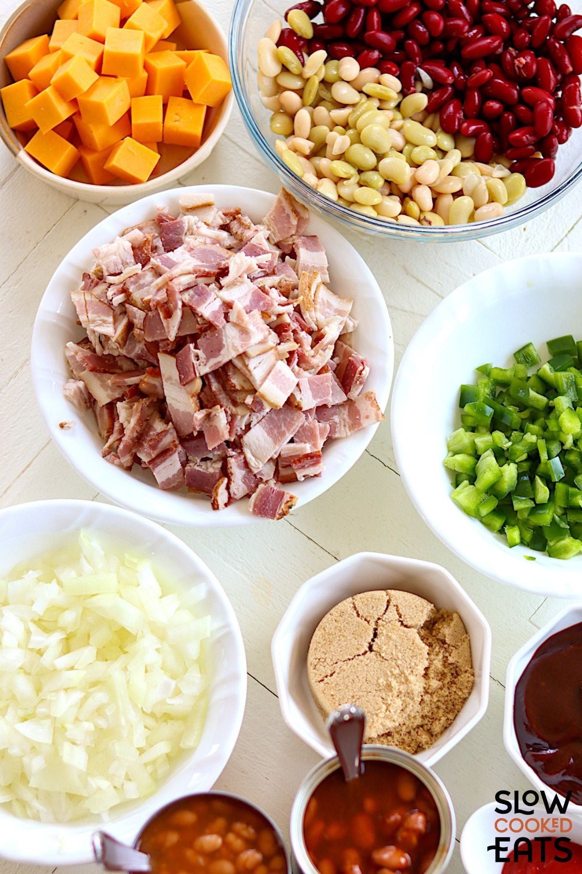 Image of ingredients needed for crockpot baked beans with bacon and cheese.