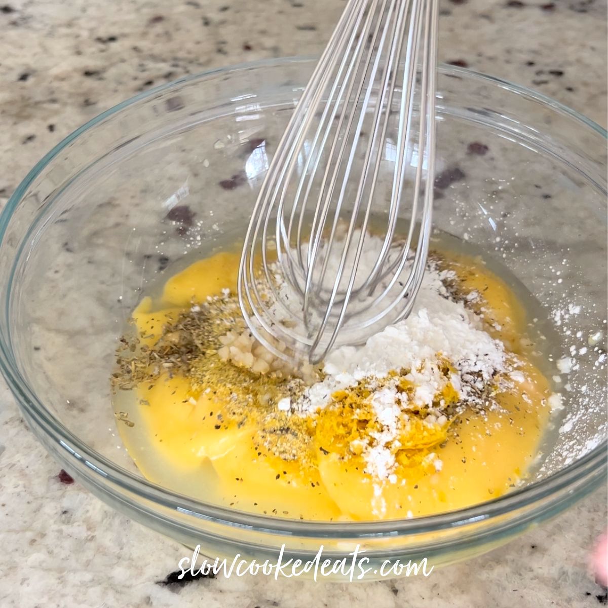 Mixing the lemon sauce in a small clear bowl.