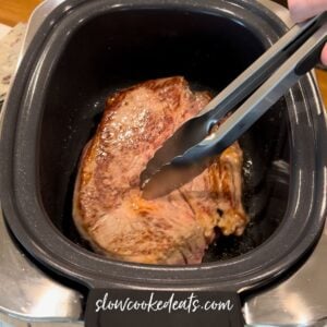 Searing the chuck roast in the crock pot.