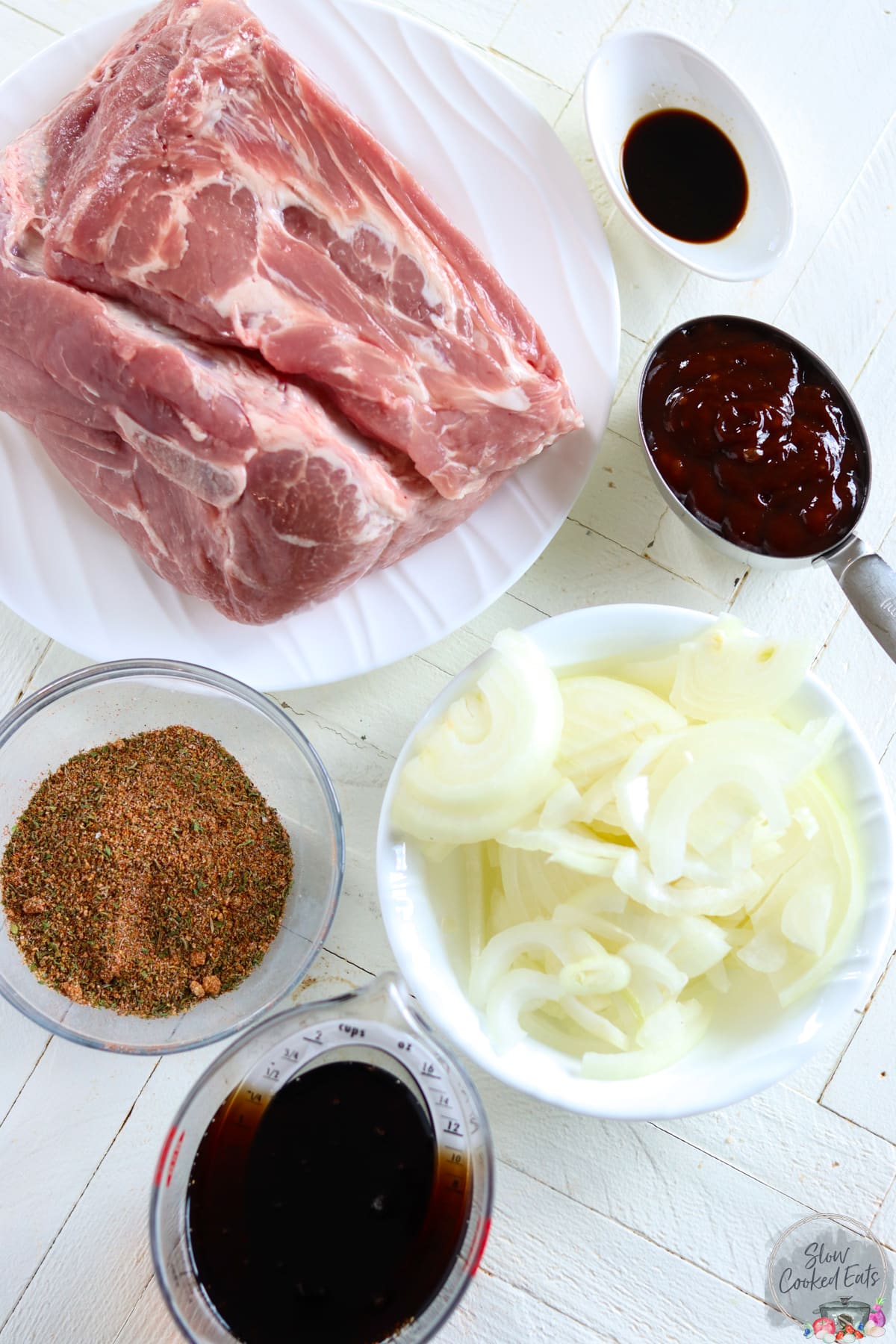 Ingredients needed to make dr pepper pulled pork on a white board.