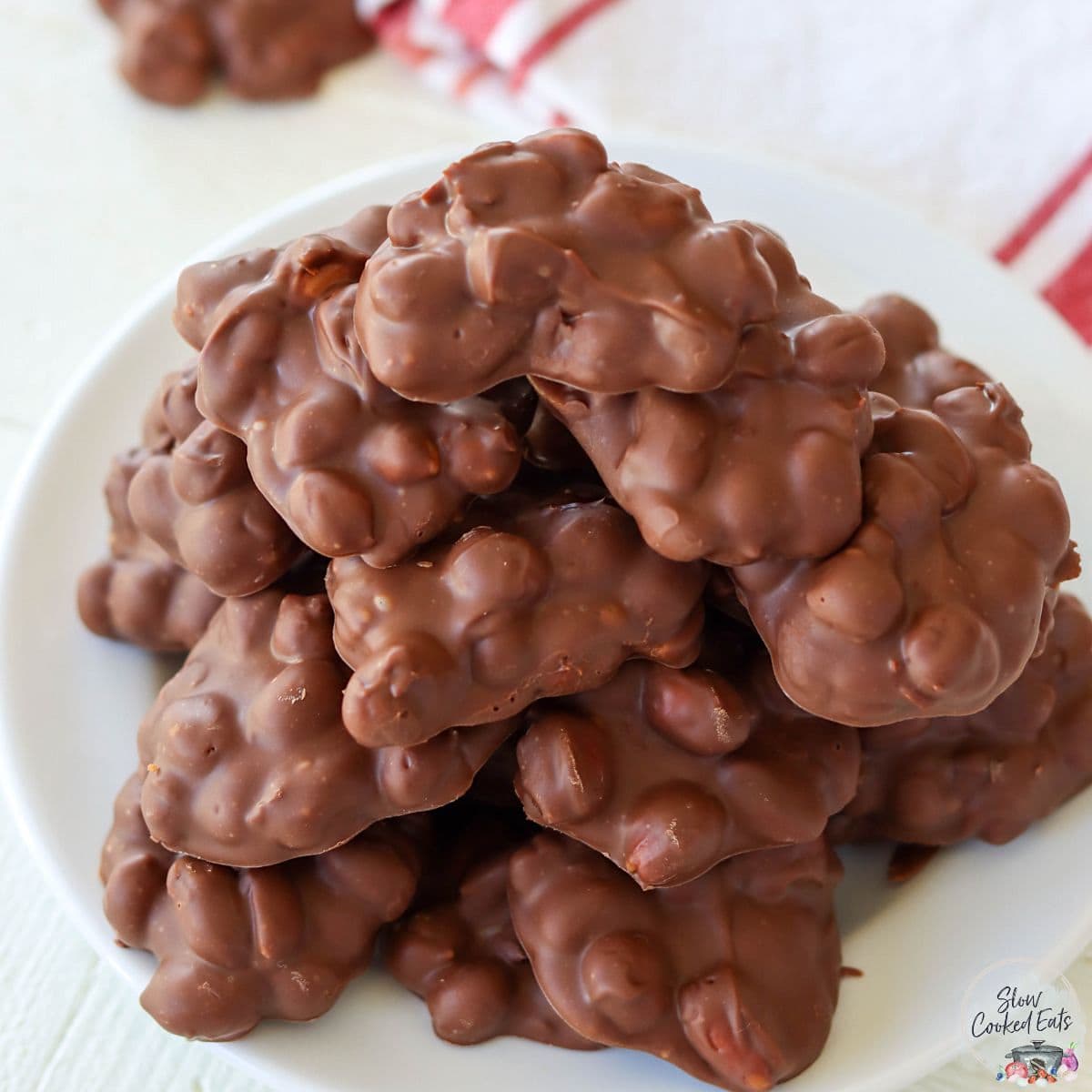 A white plate served with peanut clusters.