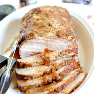 A sliced juicy pork loin made in a slow cooker.