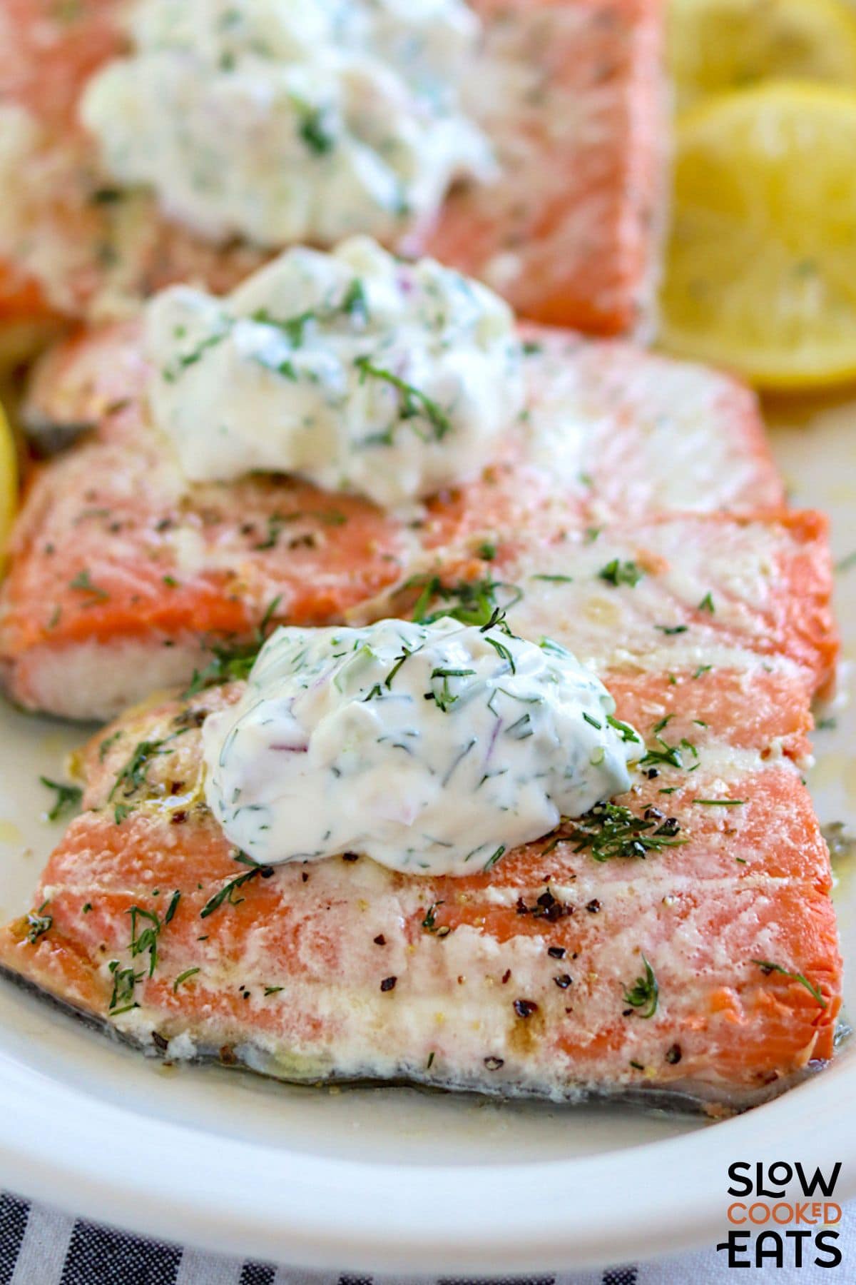 Crockpot poached salmon with dill sauce plated.