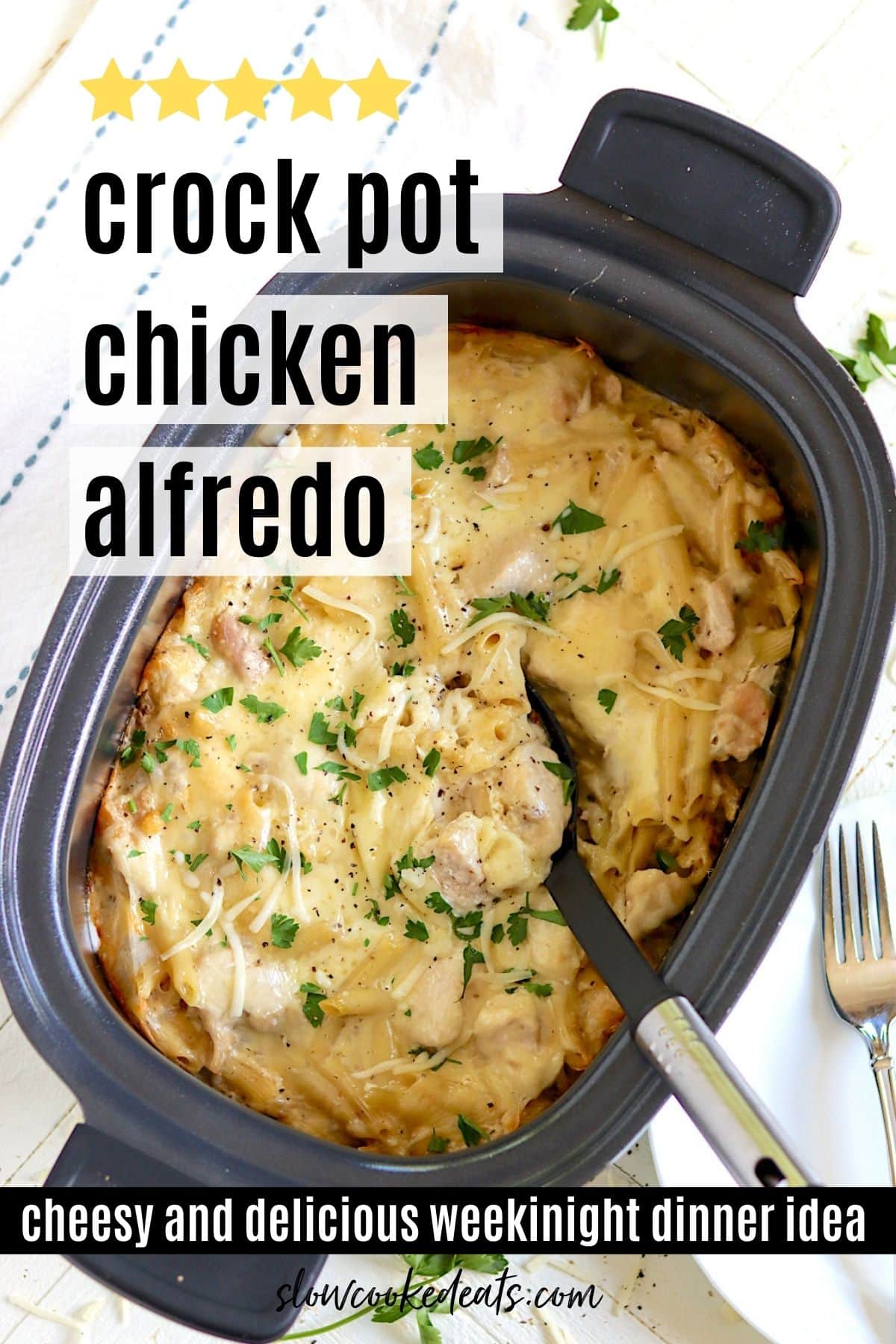 An oval black crock pot with cooked crock pot chicken alfredo.