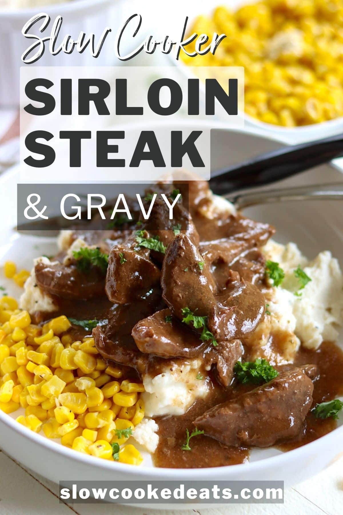 Pinterest pin with a white bowl of sirloin steak with gravy mashed potatoes and corn.
