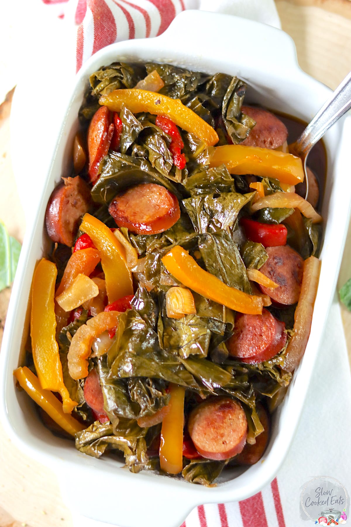 A white rectangle serving dish with cooked crockpot collard greens.