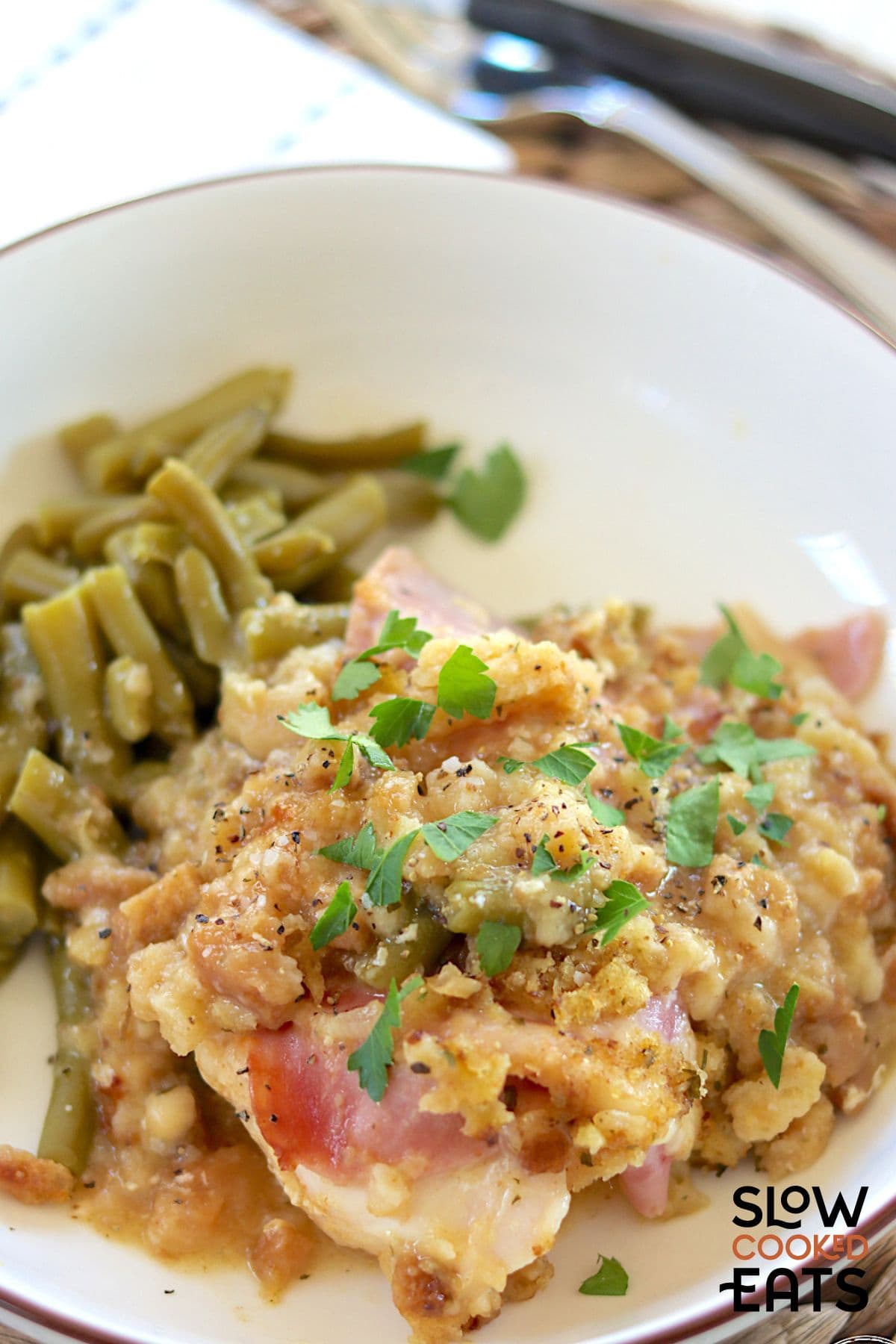 Plate chicken cordon bleu with stuffing cooked in the crock pot and served with vegetables.