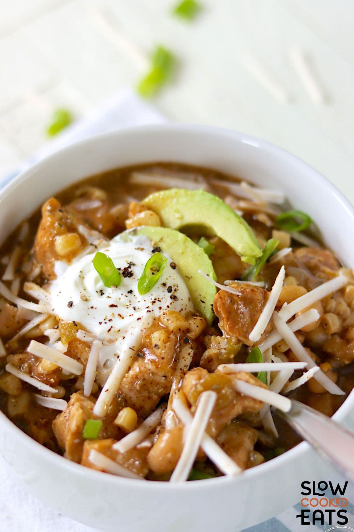 Bowl of slow cooker white chicken chili with a spoon.