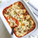 Crockpot lasagna served in a white rectangle slow cooker.