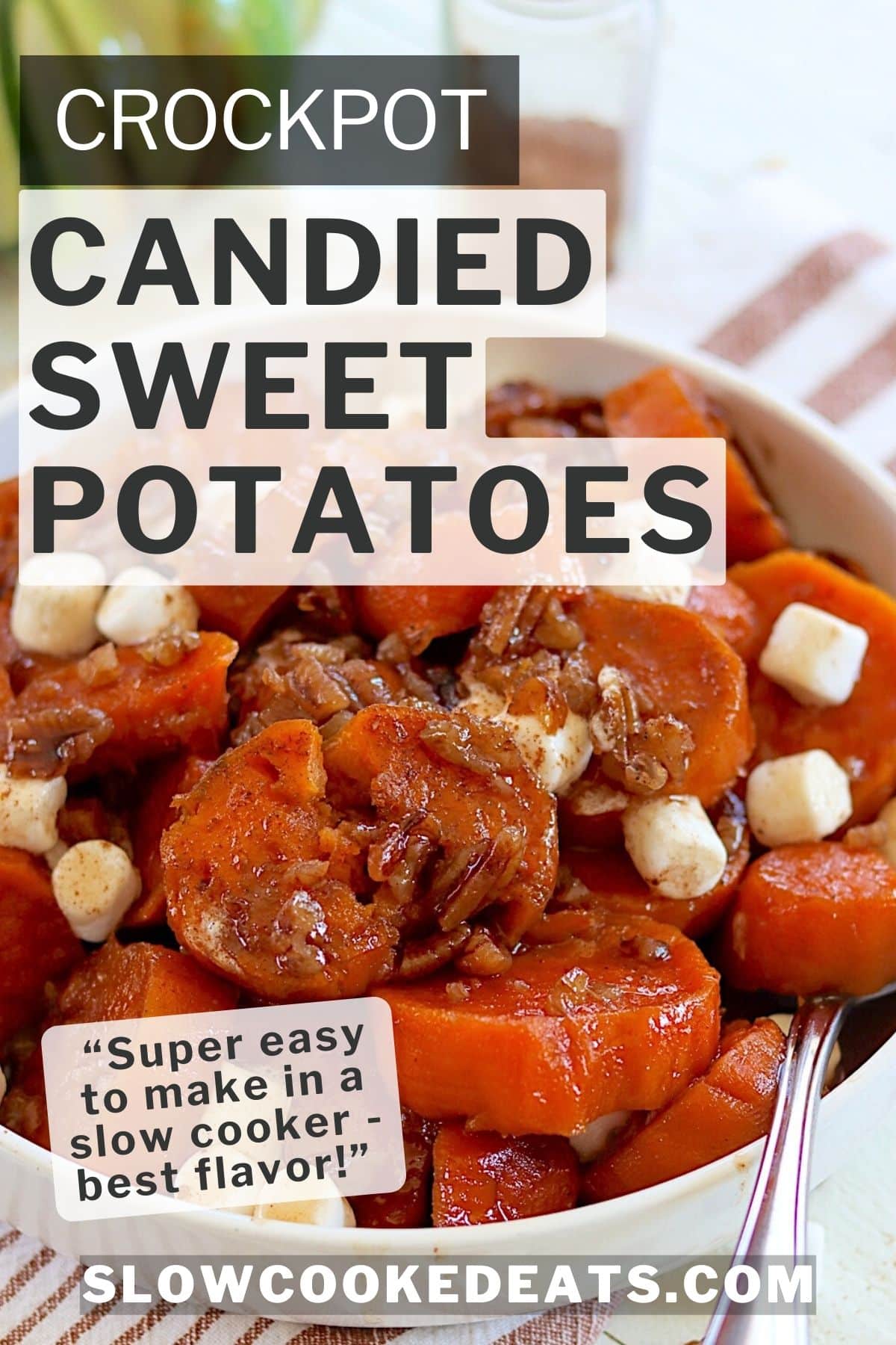 Sliced crockpot candied sweet potatoes piled high in a white bowl with pecans and marshmallows.