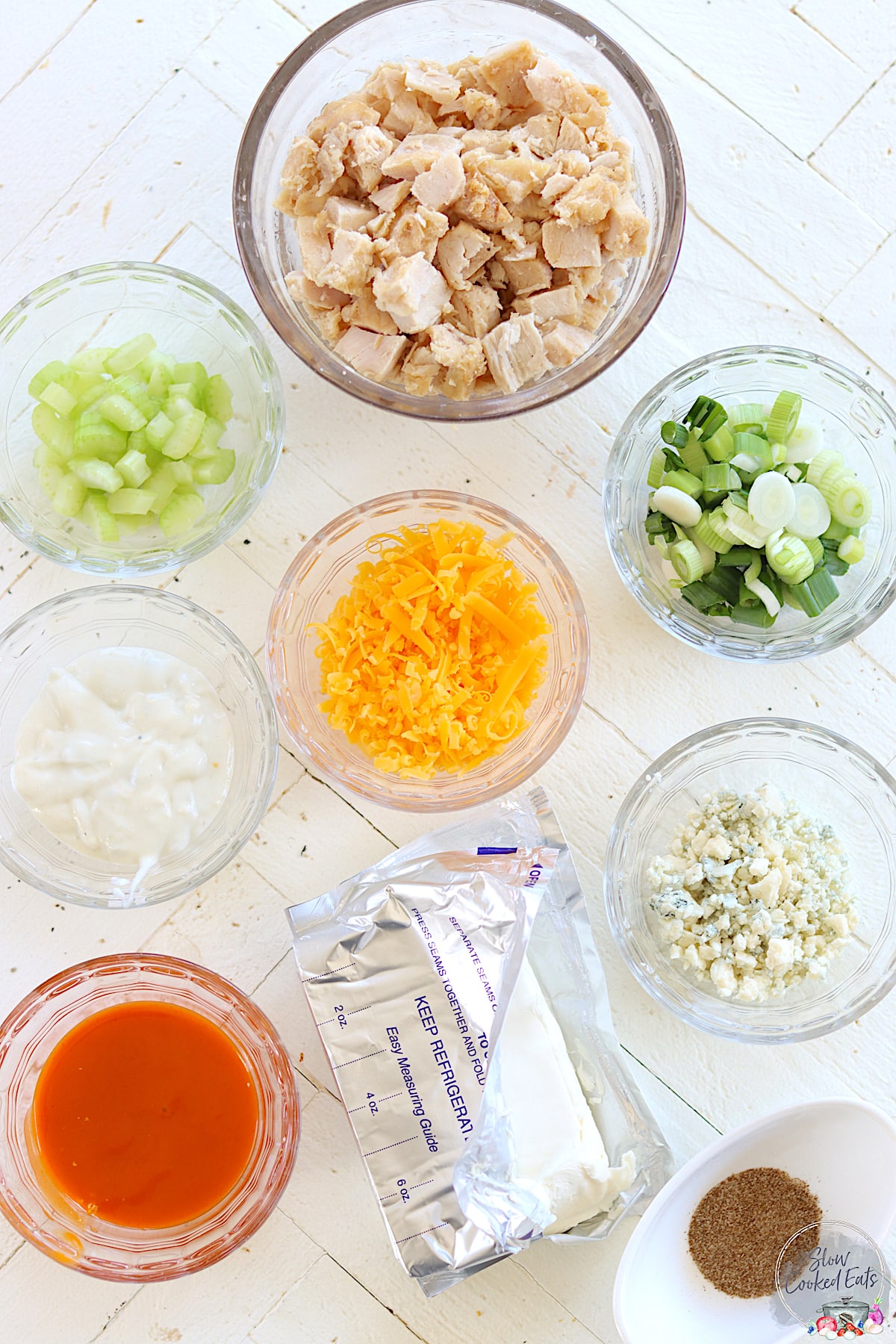 Ingredients needed for making slow cooker buffalo chicken dip.