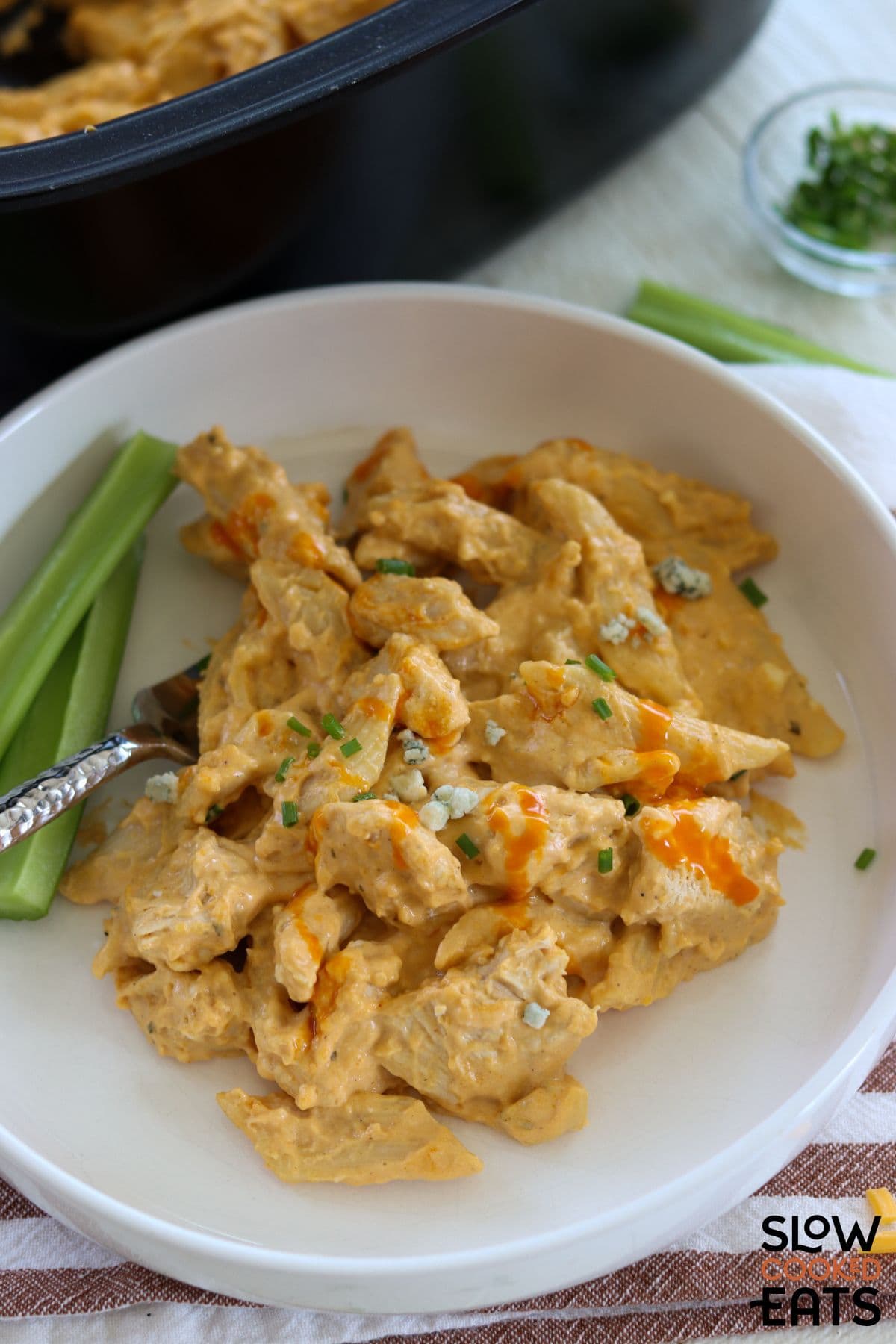 Creamy buffalo chicken pasta spooned onto a plate.