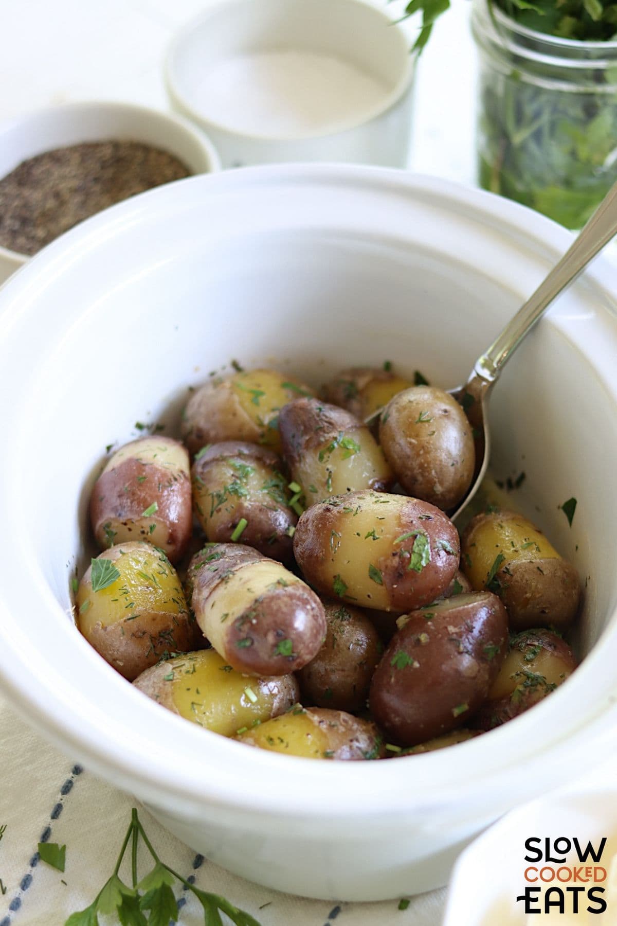 Crockpot baby potatoes being cooked in a lemon herb sauce.