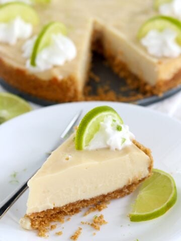 A slice of crockpot key lime pie on a white plate.