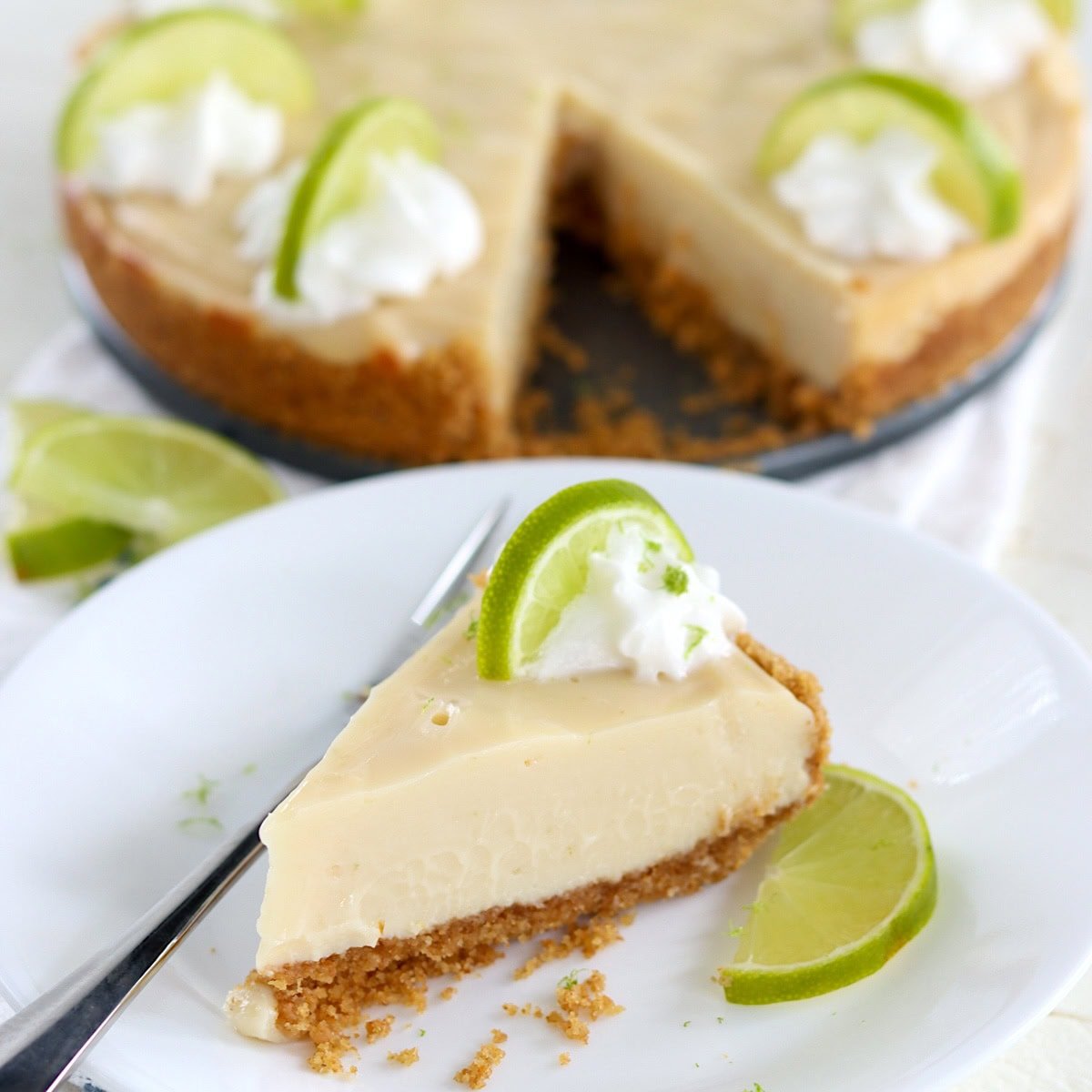 A slice of crockpot key lime pie on a white plate.