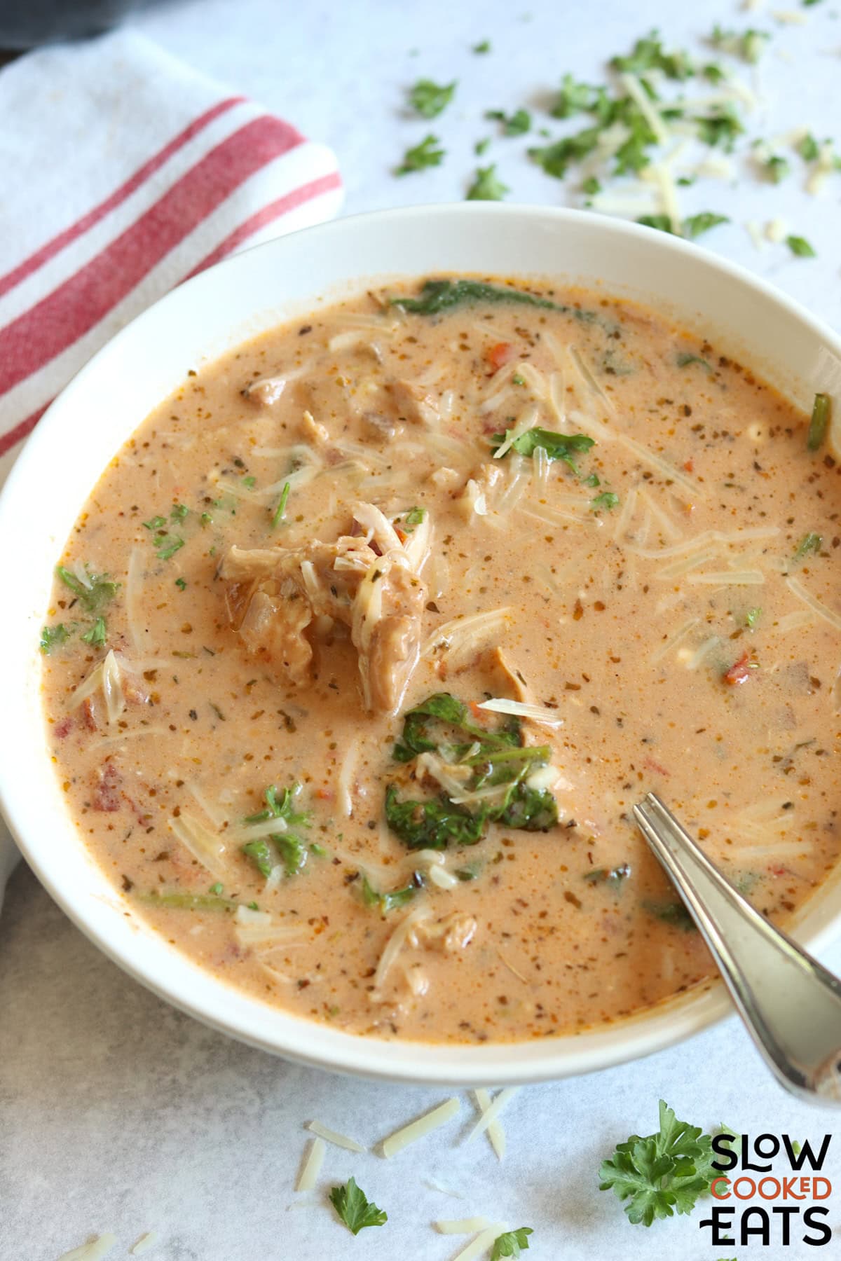 A bowl of marry me chicken soup crock pot recipe on a white board.