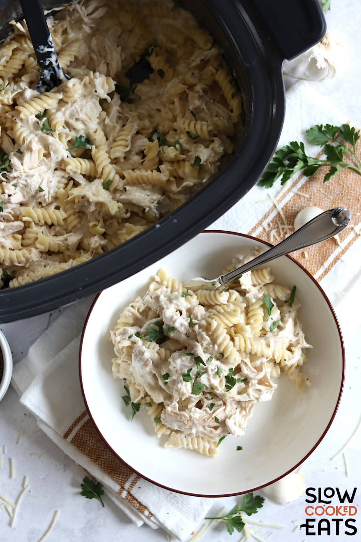 Crockpot garlic parmesan chicken pasta in a white bowl.