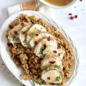Crockpot turkey and stuffing served on a white platter and silver spoon.