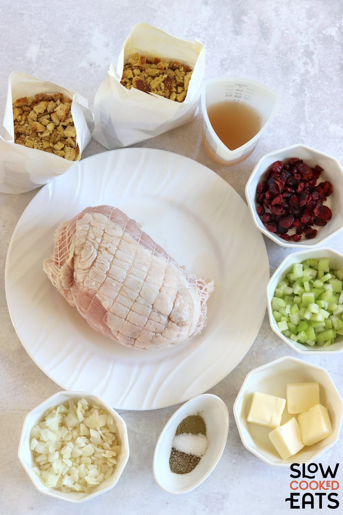 Ingredients needed to make crockpot turkey and stuffing on a marble countertop.