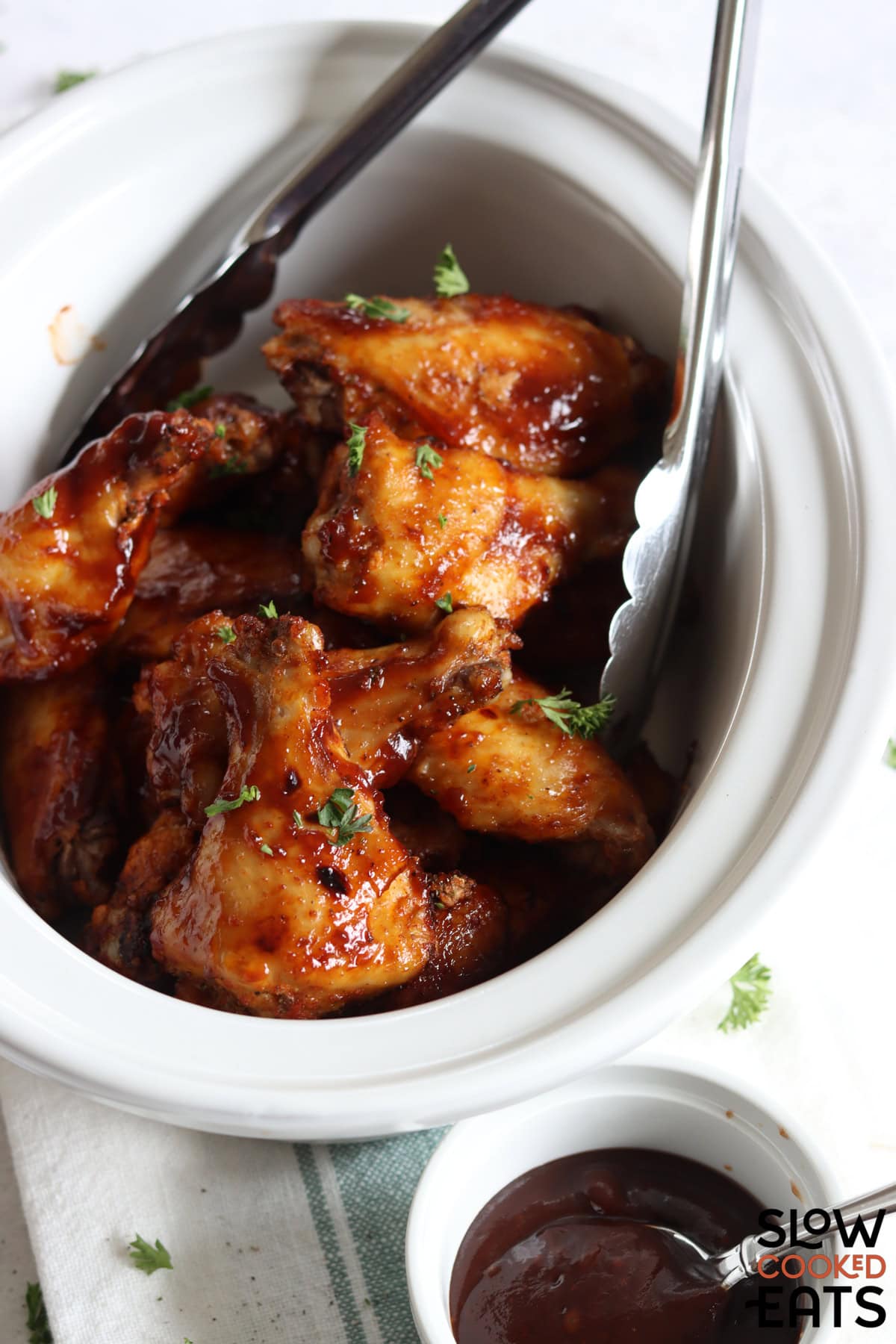 White oval slow cooker with BBQ Chicken wings crockpot