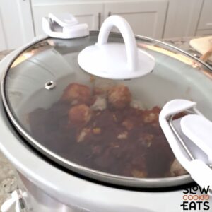 Slow cooking the crockpot cranberry meatballs.