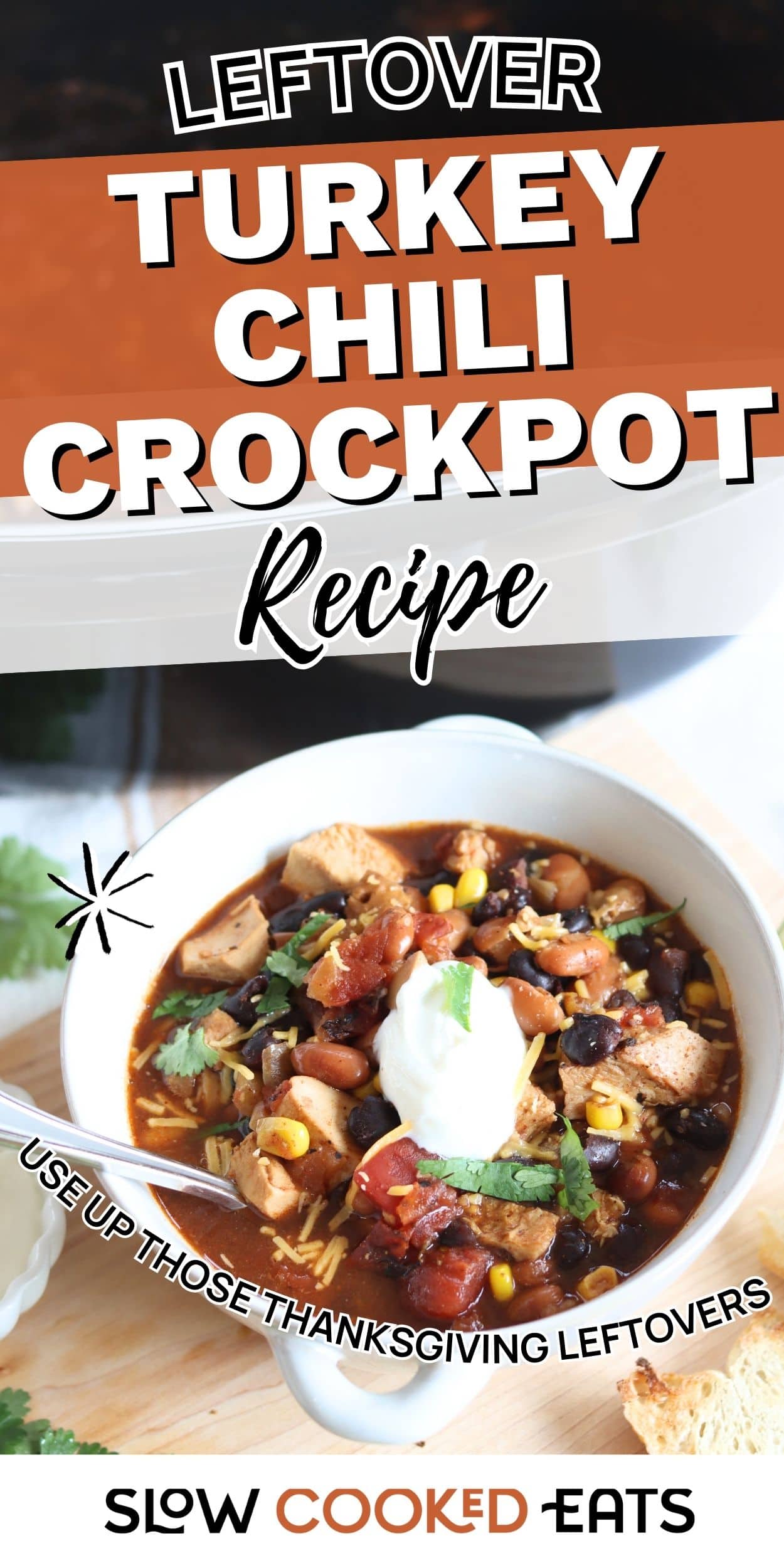 Bowl of turkey chili with beans, tomatoes, corn, and turkey pieces, topped with sour cream, made using a crockpot leftover turkey recipe.