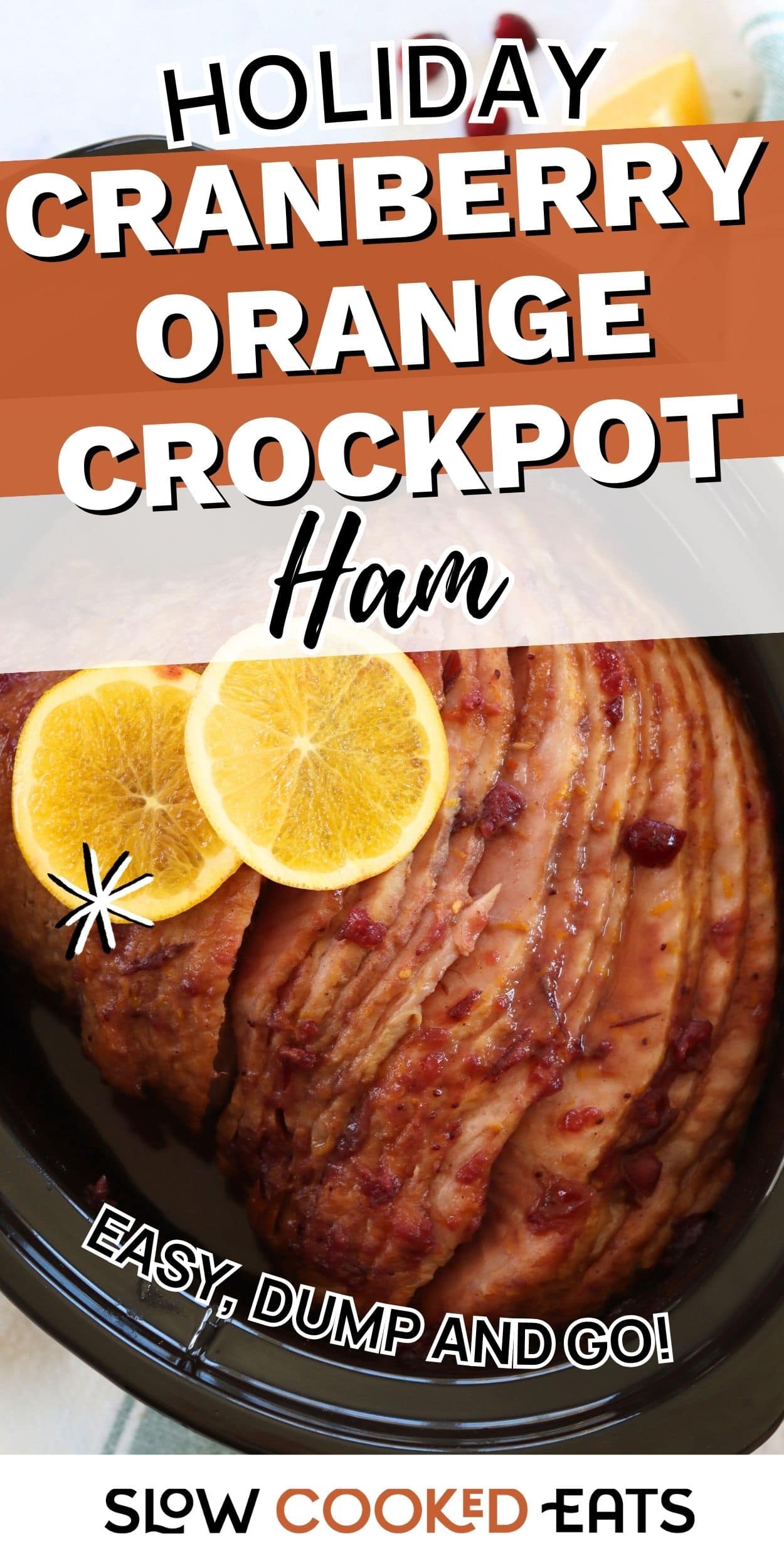Sliced ham in a slow cooker topped with cranberry glaze and orange slices, showing a cranberry orange crockpot ham.