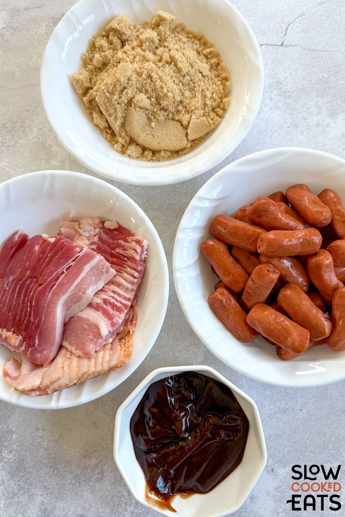 Ingredients needed to make crockpot little smokies wrapped in bacon on a white marble countertop.
