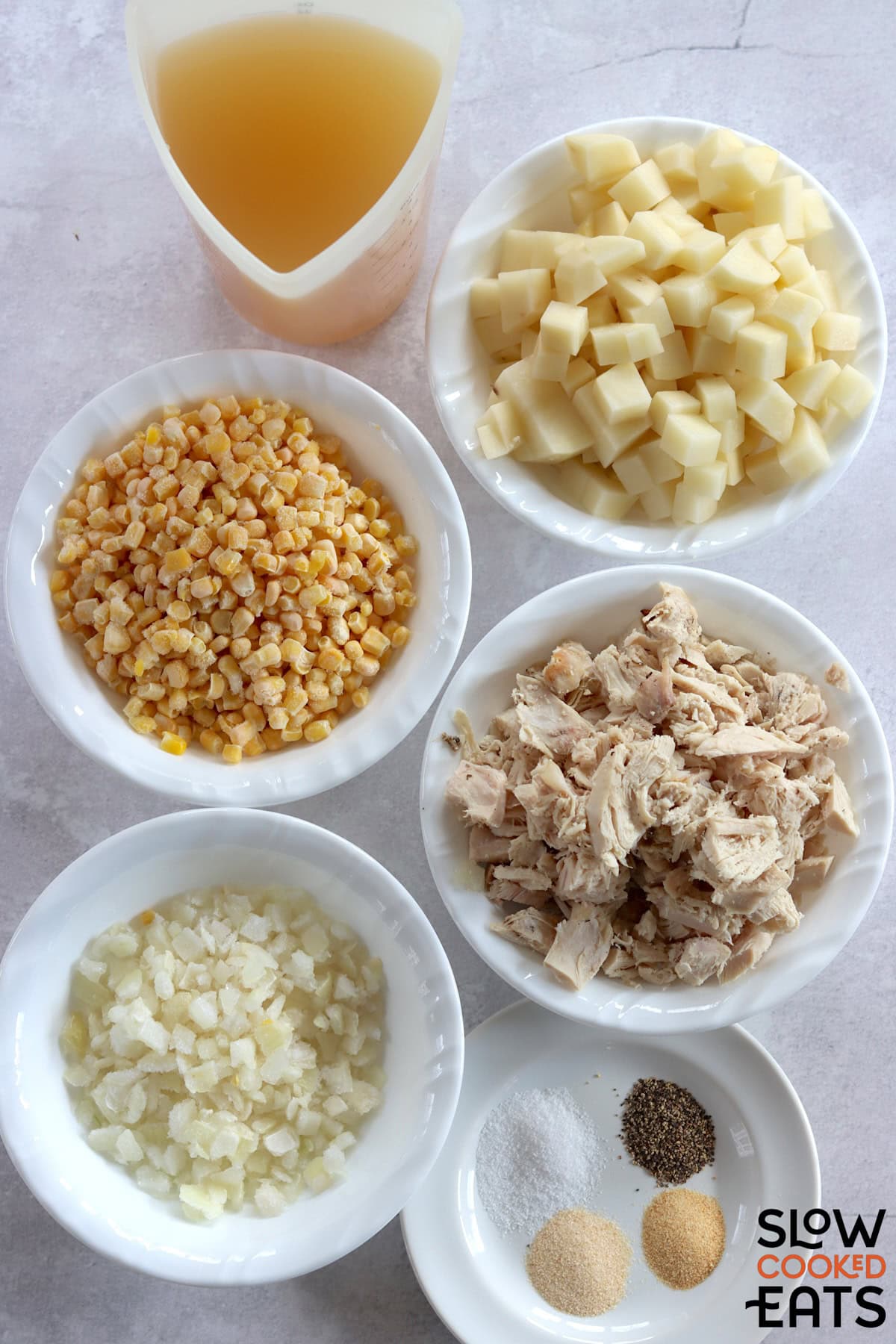Ingredients needed to make leftover turkey corn chowder crockpot recipe on a white marble countertop.