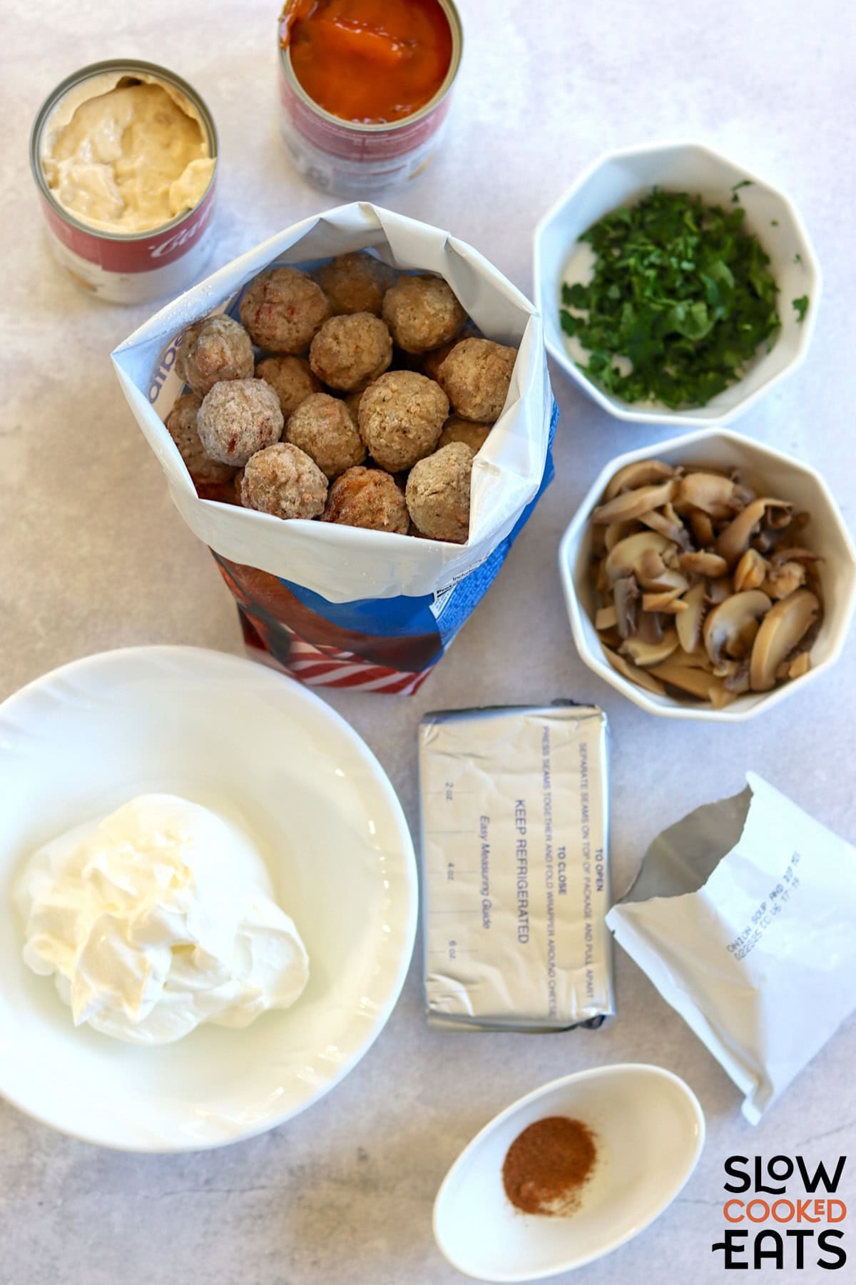 Ingredients needed to make Swedish meatballs crockpot recipe on a white marble countertop.