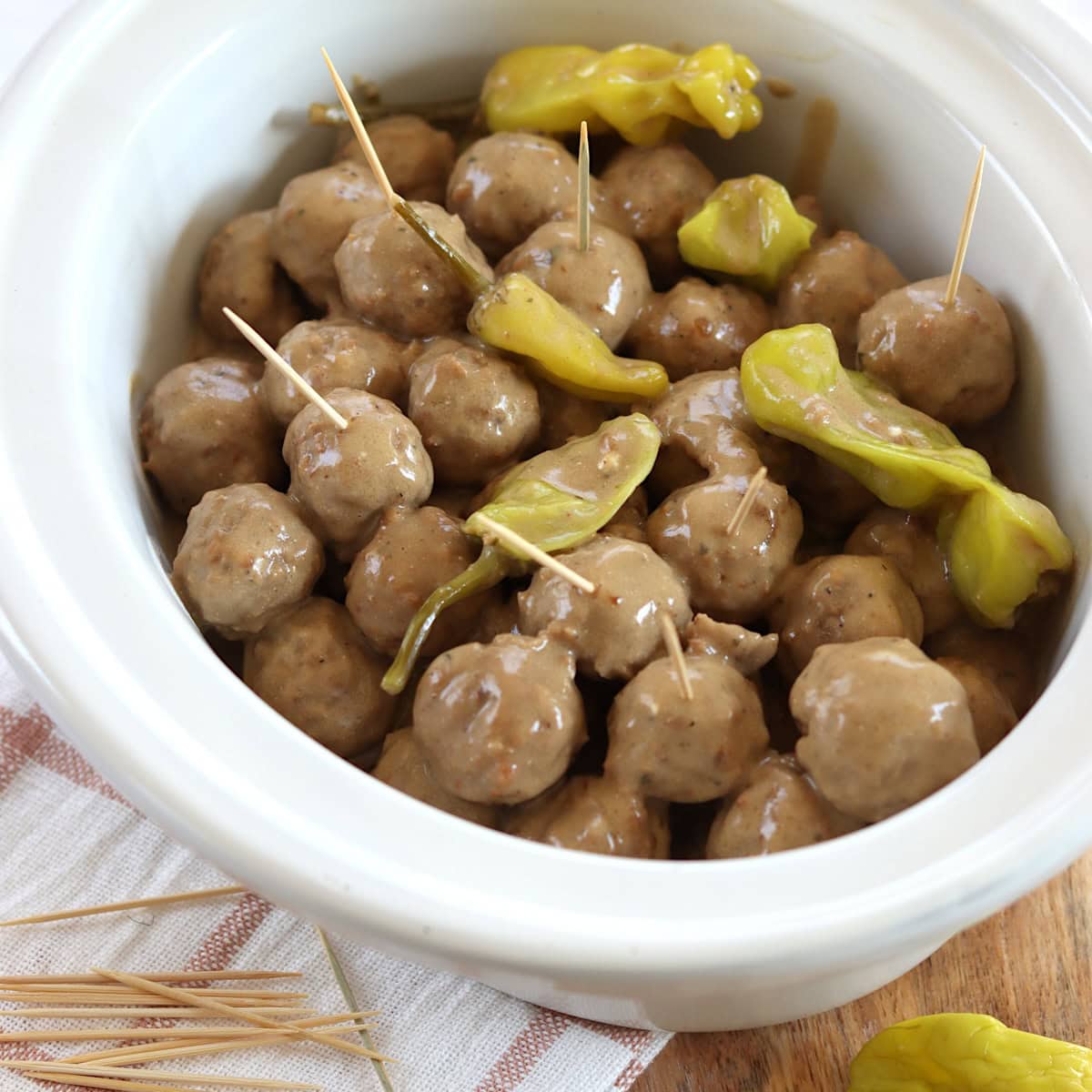 Mississippi meatballs crockpot recipe in a white oval slow cooker.