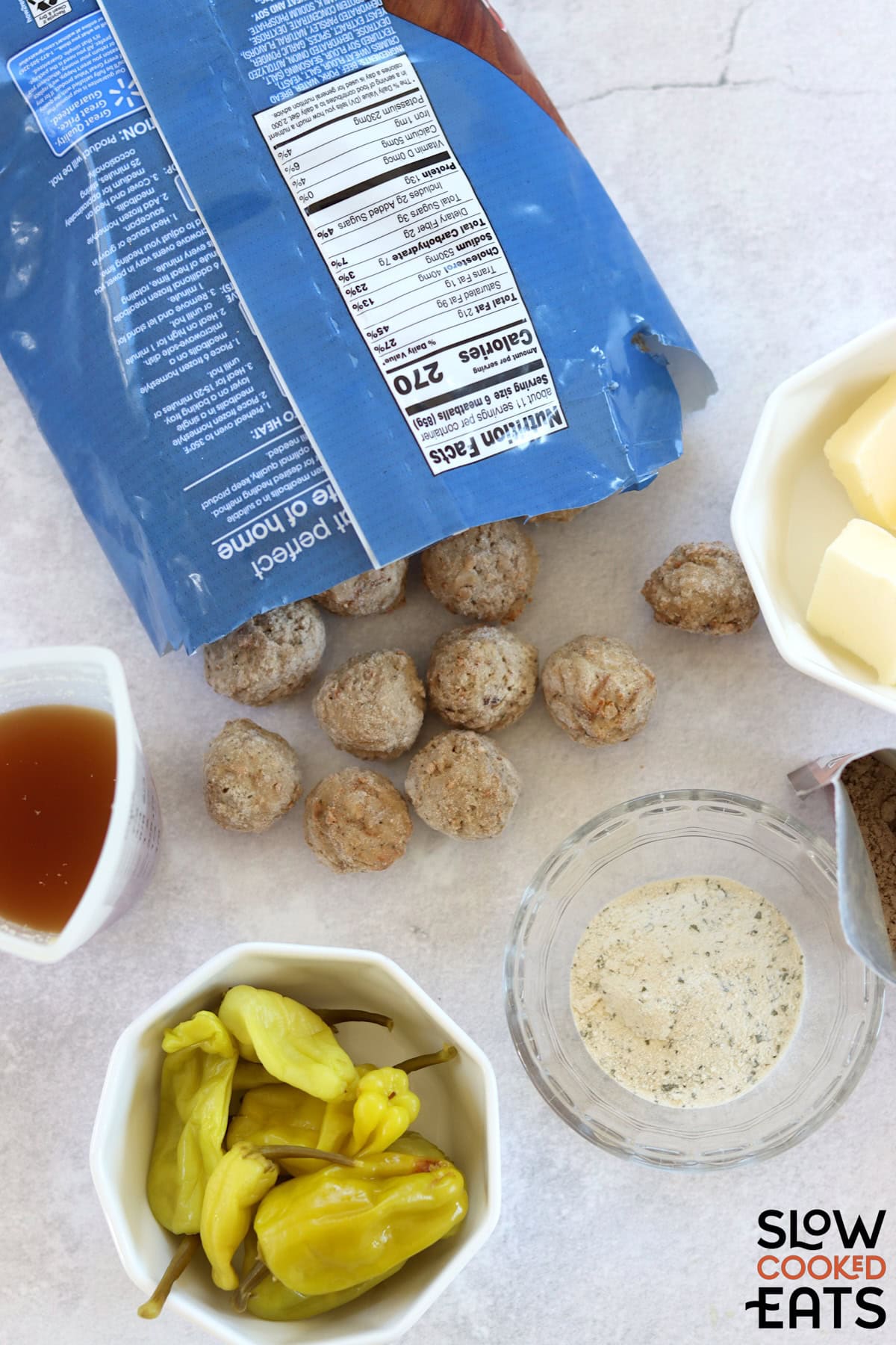 Ingredients needed to make Mississippi meatballs crockpot recipe on a white marble countertop.