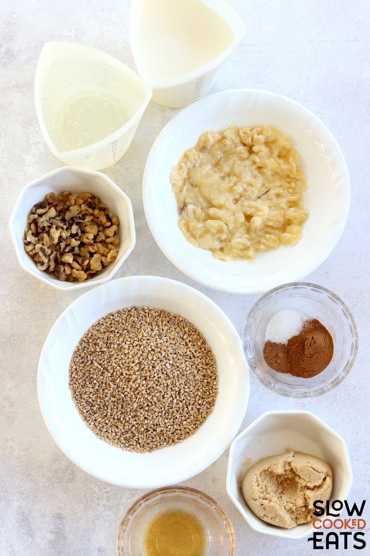 Crockpot banana oatmeal recipe ingredients on a white marble countertop.