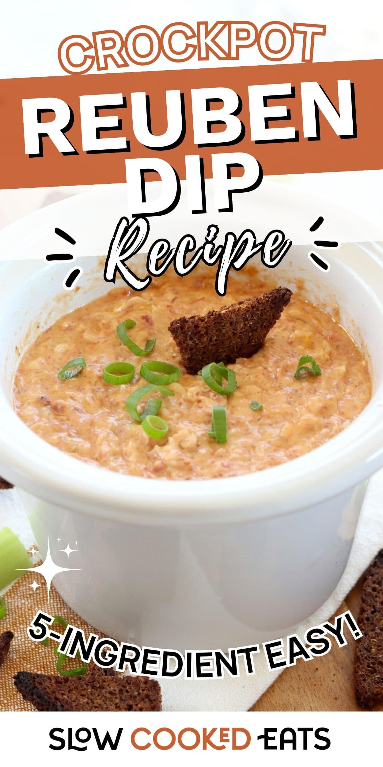 Creamy crockpot Reuben dip in a white slow cooker topped with green onions and served with rye bread. Easy crockpot Reuben dip recipe perfect for warm party dips.