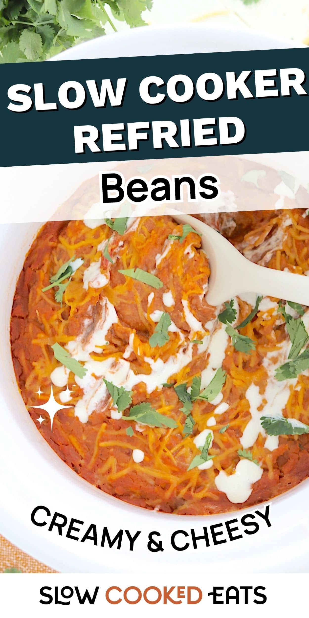 A bowl of slow cooker refried beans topped with melted cheese, sour cream, and fresh cilantro. This creamy Crock Pot refried beans recipe looks rich, comforting, and perfect for Mexican-inspired meals.