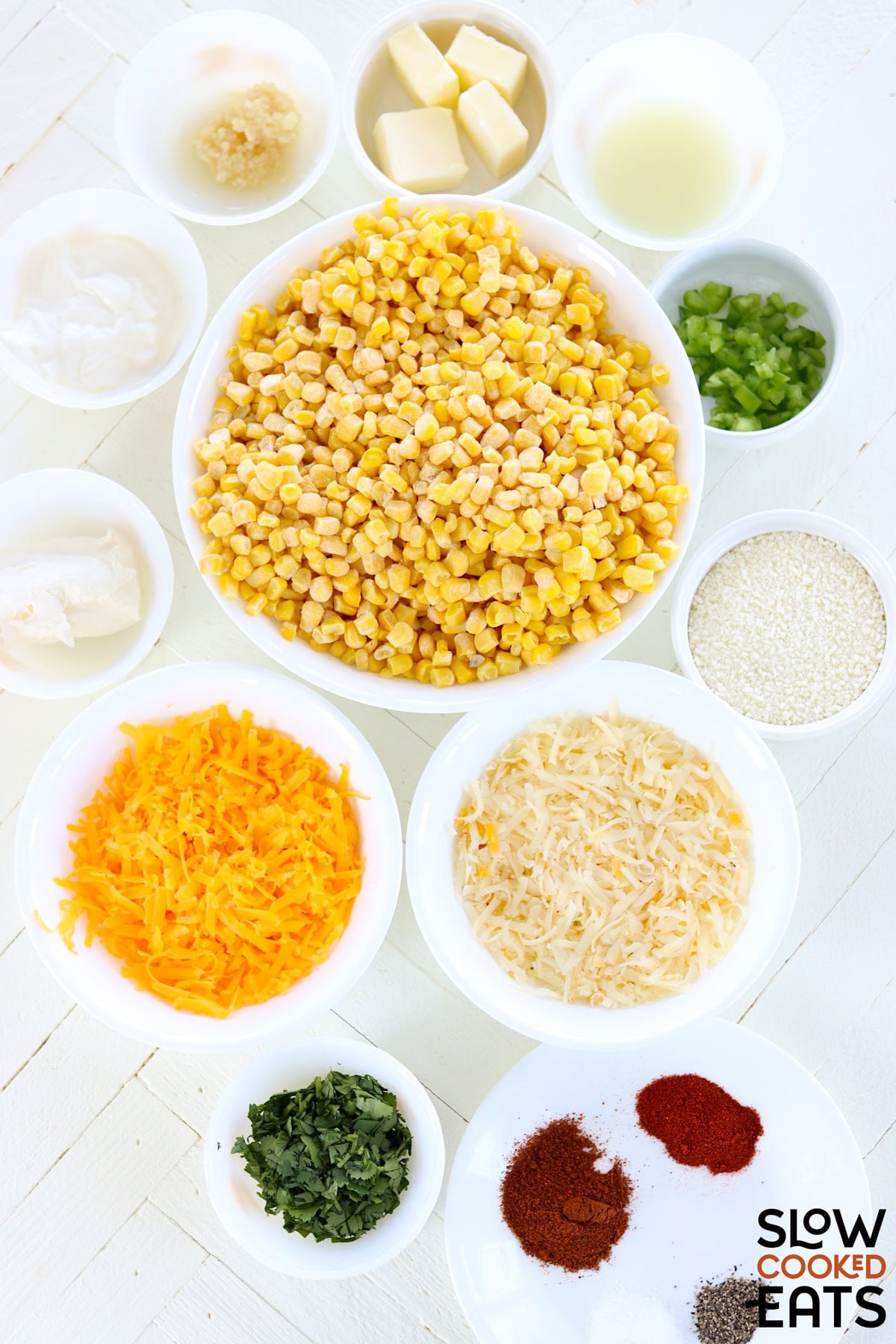 Ingredients needed to make Mexican street corn crockpot recipe arranged on a white countertop.