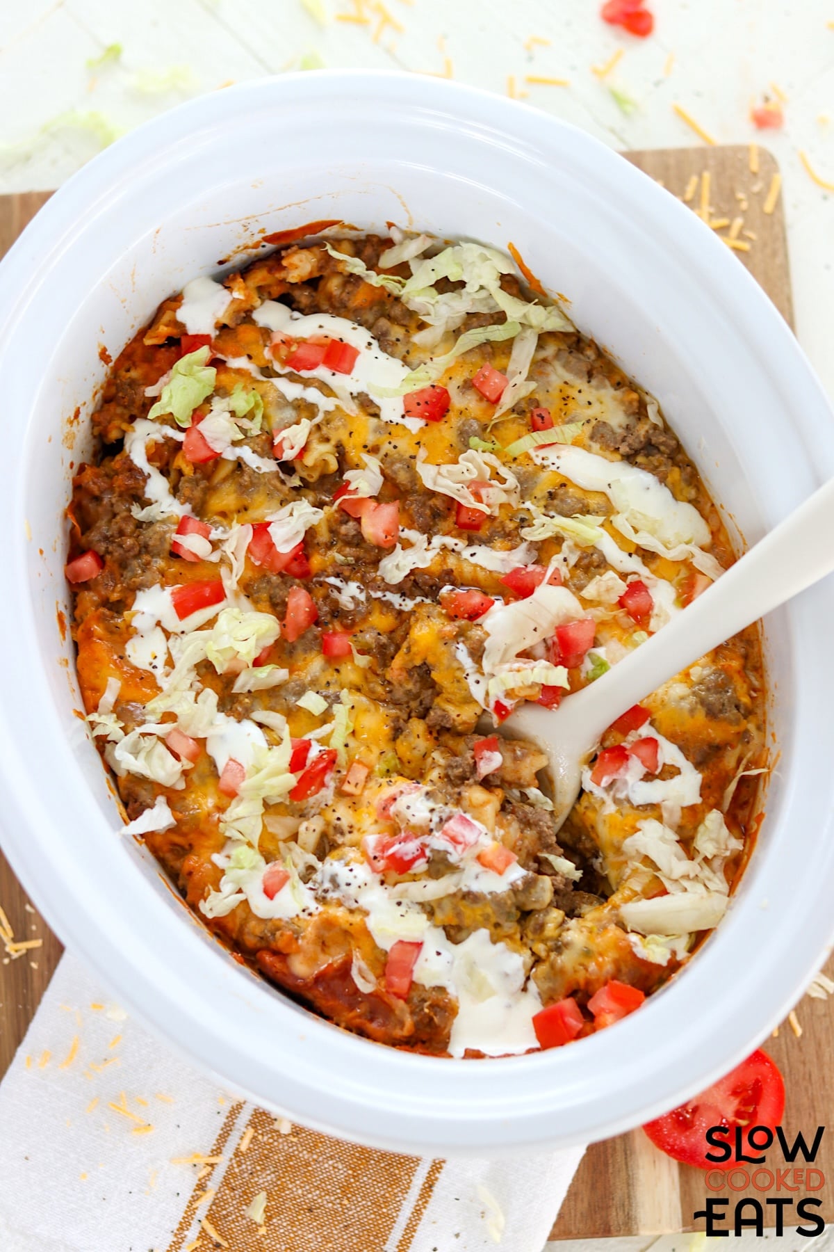 Slow cooker taco pasta in a white oval crockpot.