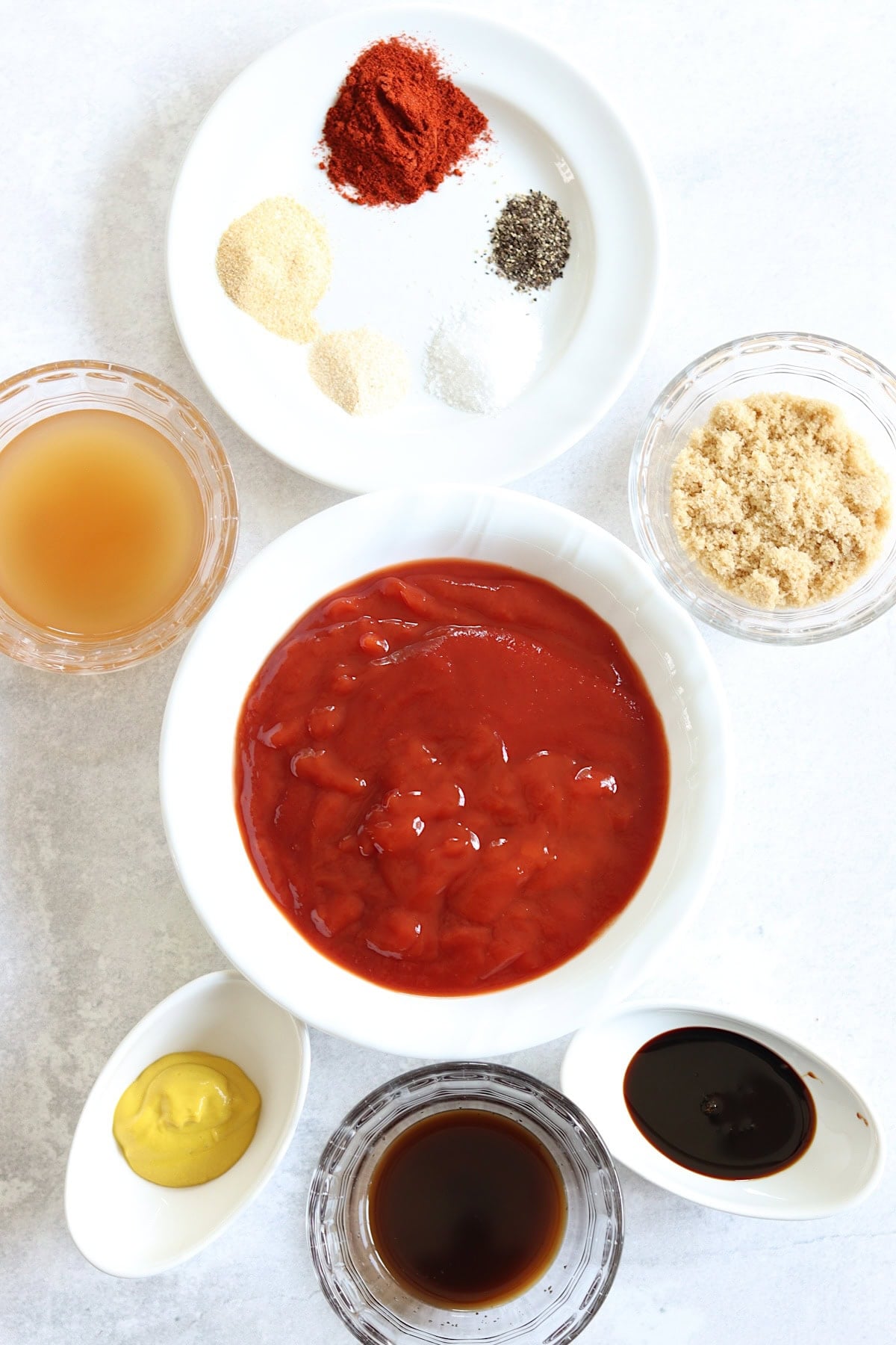 Ingredients needed to make slow cooker BBQ sauce on a white board.